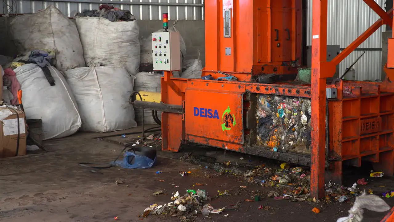 Static view of a waste compactor machine with a yellow light flashing