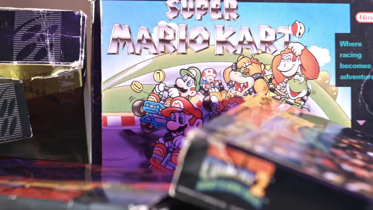 Vintage Super Mario Kart Box with Other Games Surrounding in Purple Light SLIDE RIGHT