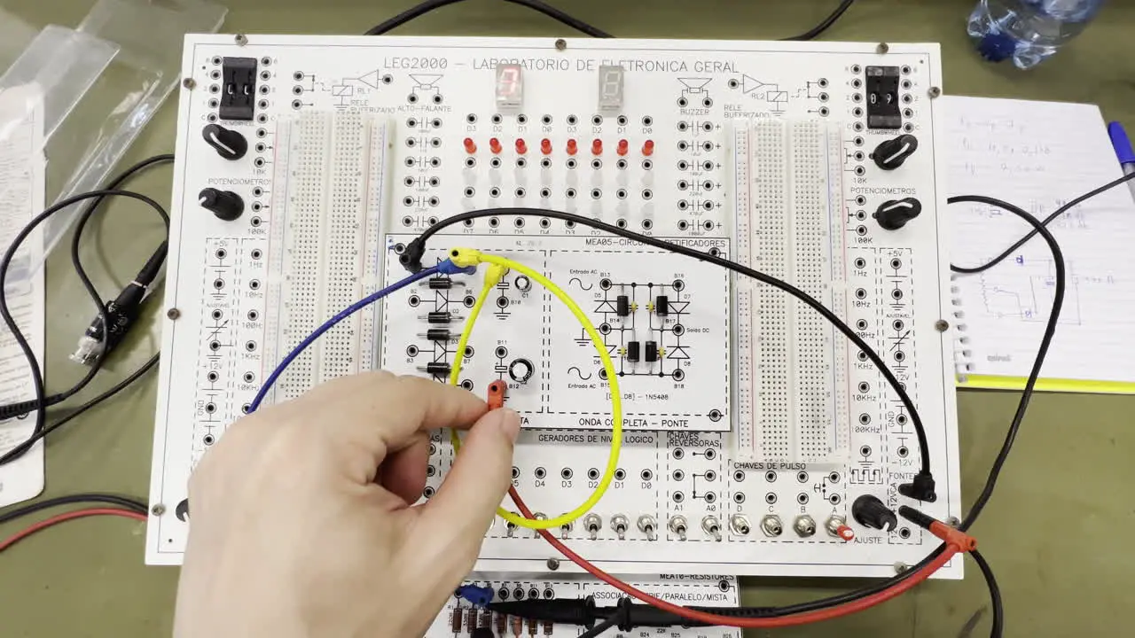 Engineer Hand Experimenting With Electronic Components On Breadboard