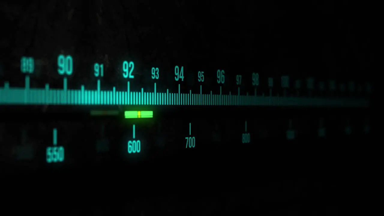 A static sequence of a radio tuner display with glowing light blue text and bars on a black background