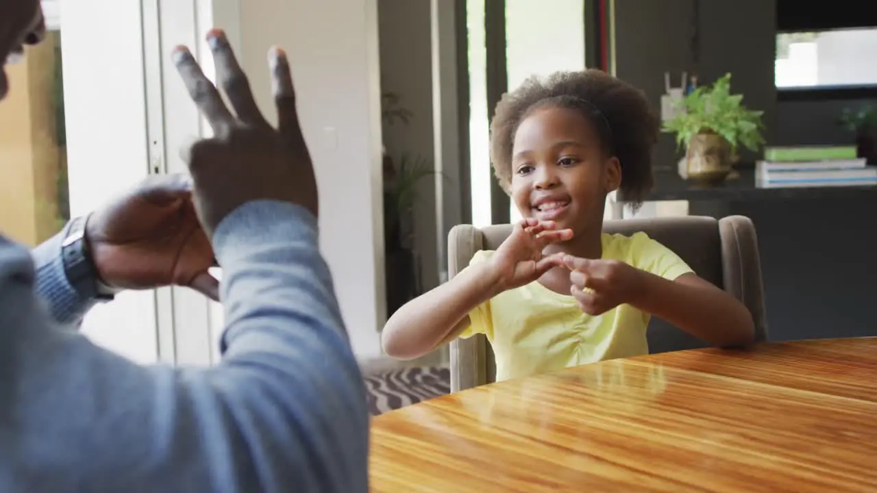 Video of african american father and daughter using sign language