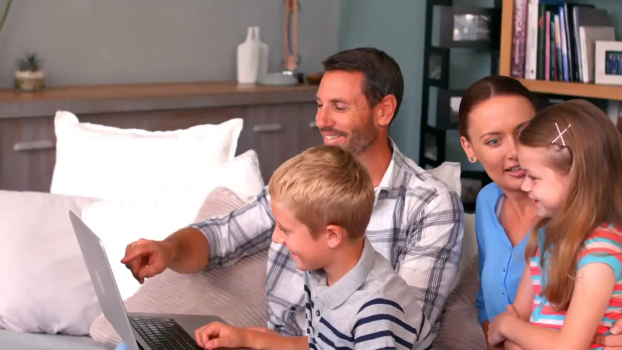 Family using laptop on couch