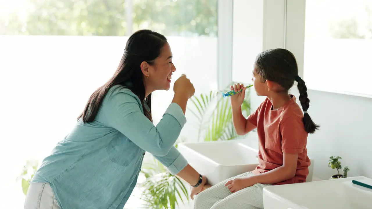 Mother high five or kid in bathroom brushing