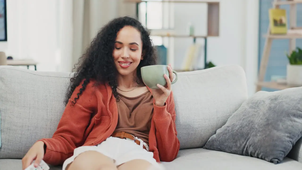 Woman relax on sofa coffee cup and watching tv