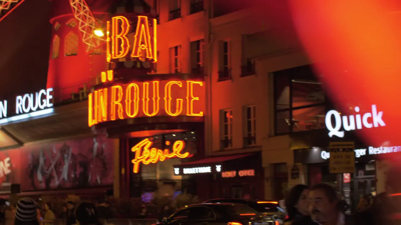 Street with Moulin Rouge in Paris view at night