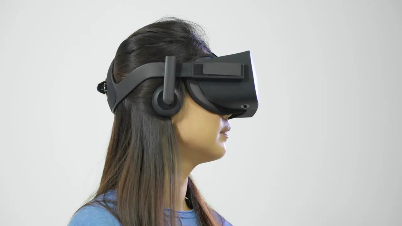 Young Woman Looking Around in Virtual Reality Headset