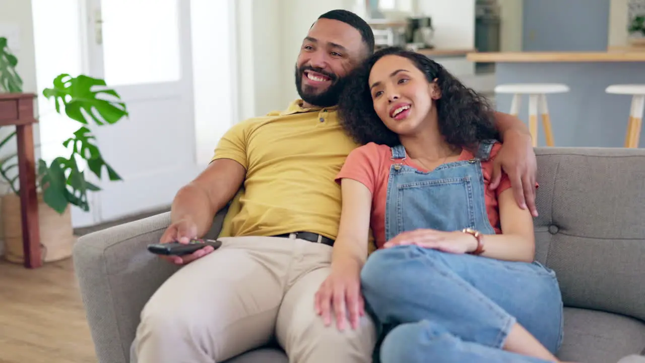 Happy couple relax and watching tv on sofa