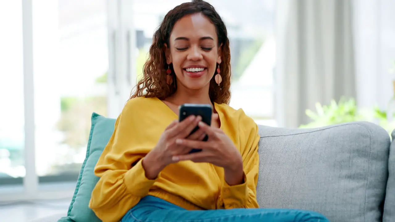 Phone laughing and woman texting on a sofa