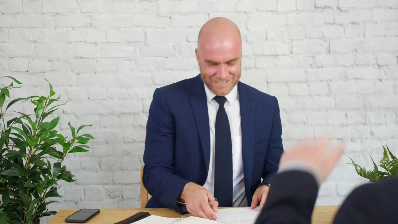 Handsome Confident Entrepreneur Businessman Talking and Laughing At Office Meeting