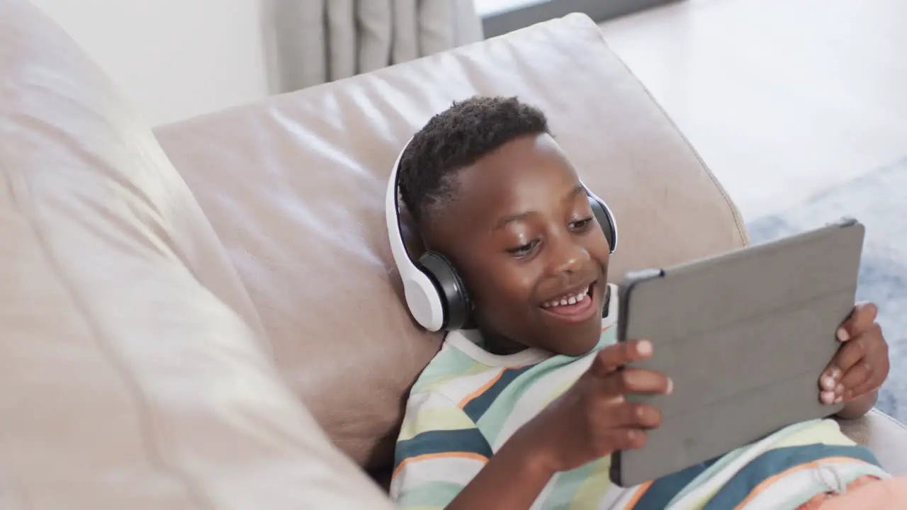 African American boy enjoys a tablet at home