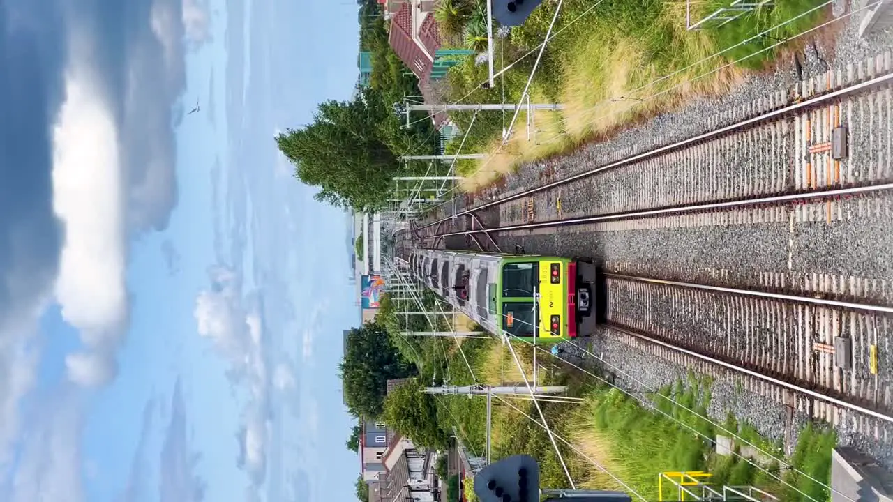 Urban Journey Dart Irish Rail Train Departing Kilbarrack Station on a Beautiful Day Vertical Video