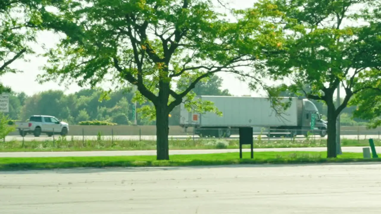 slow motion of a reefer semi tractor and trailer driving on highway