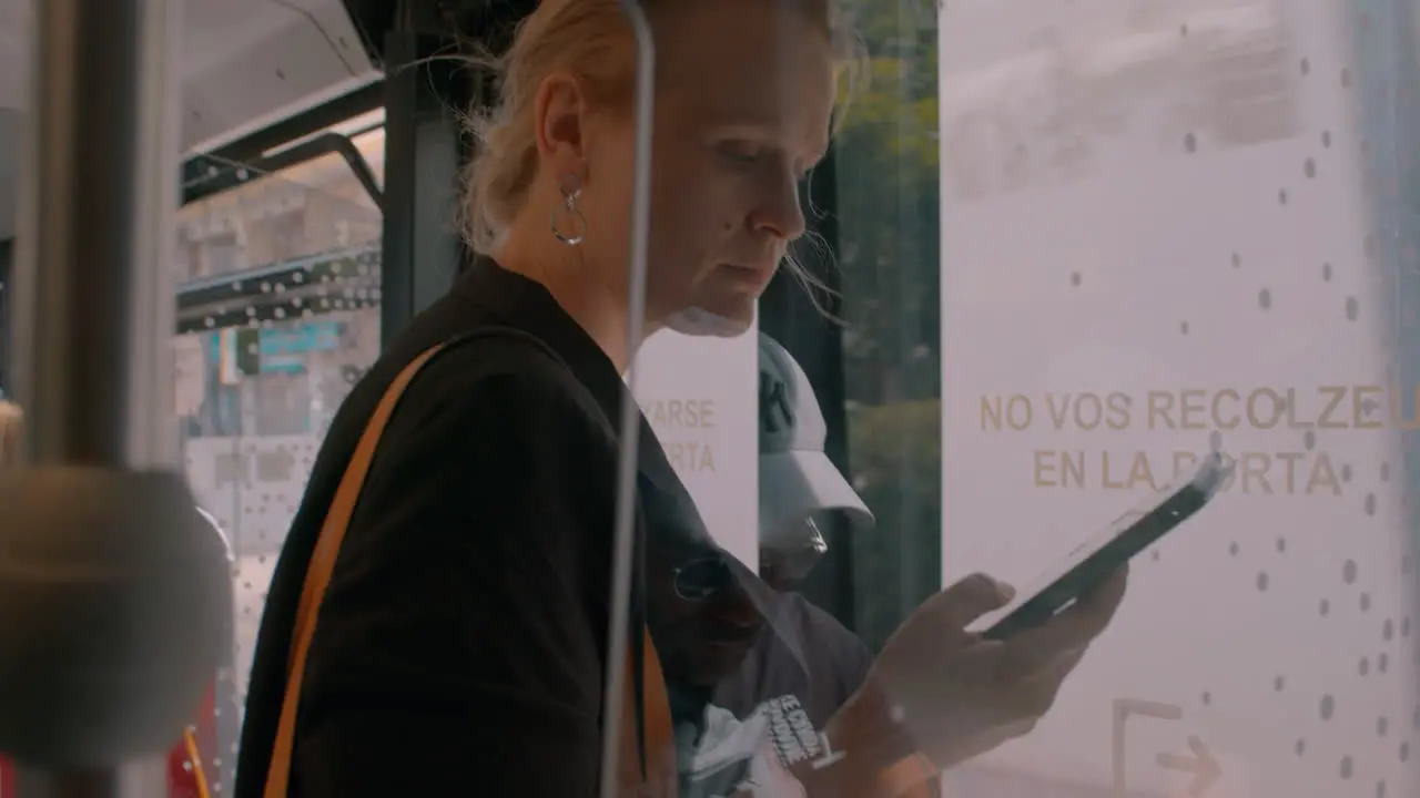 Young woman with e-book in the bus