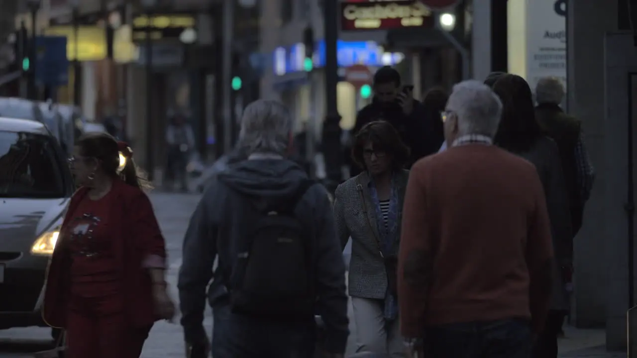 Car and people traffic in evening city