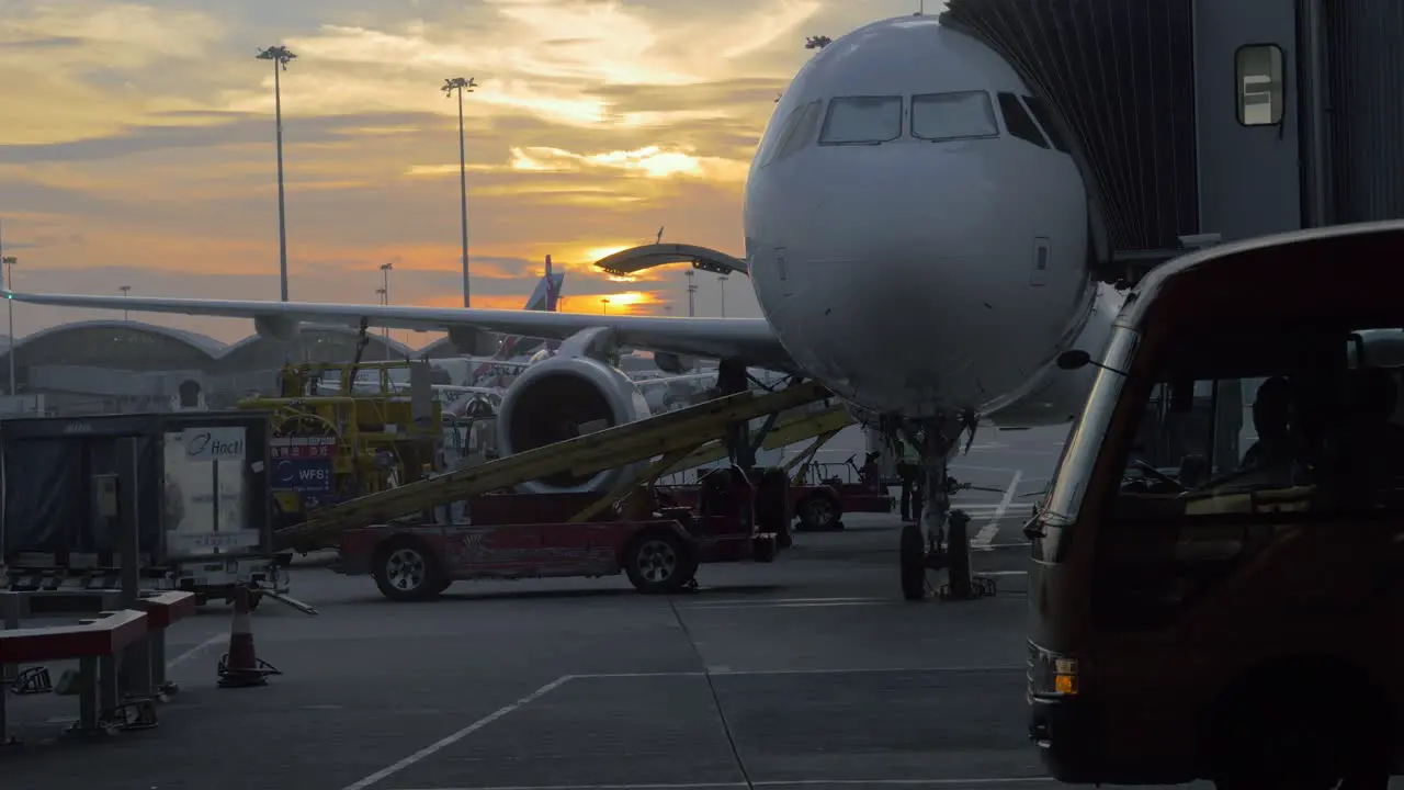 Boarding and loading airplane at sunset