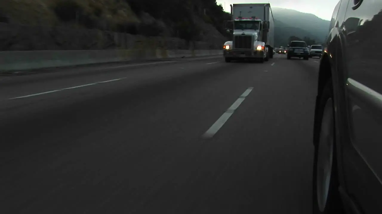 Cars and trucks drive by on a crowded highway