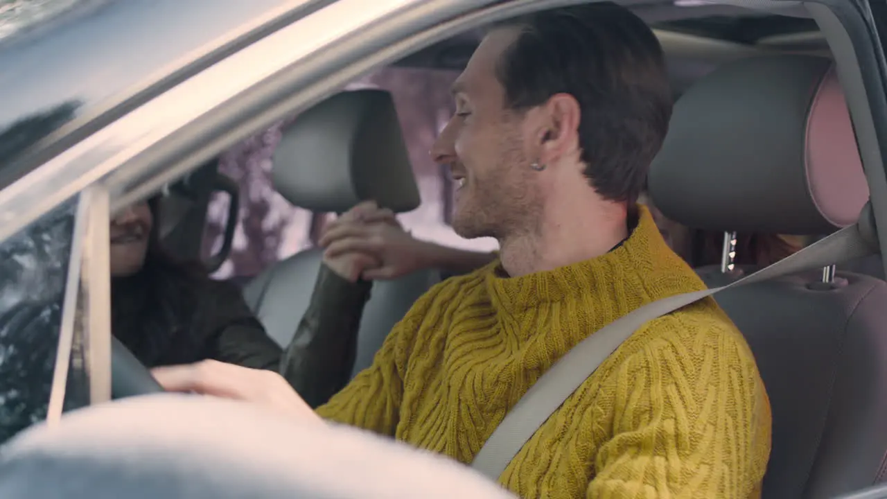 Husband And Wife Sitting In The Front Seats Of A Car 2