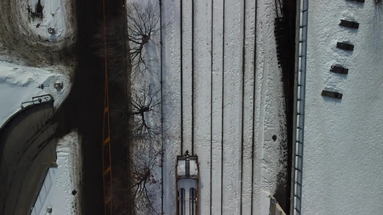 A short train passing by seen from the sky in winter season