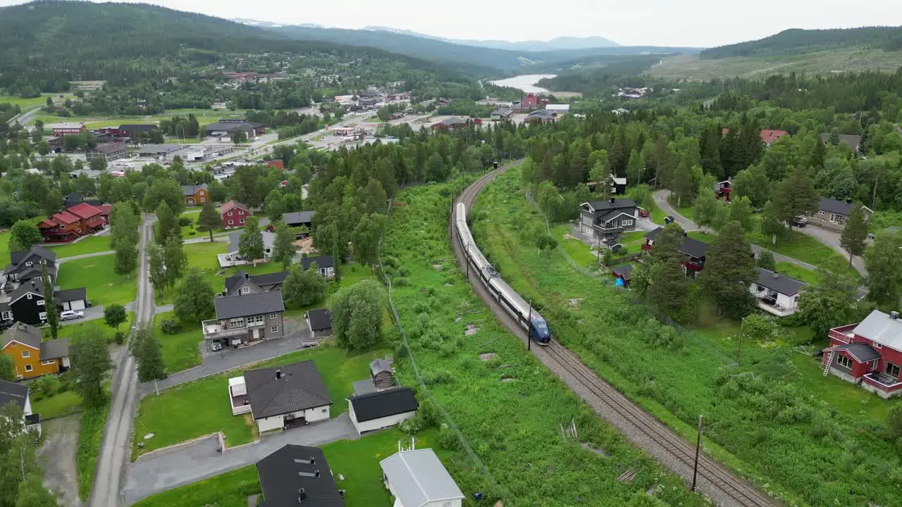 A train runs through Berkåk Rennebu Municipality in Trøndelag county