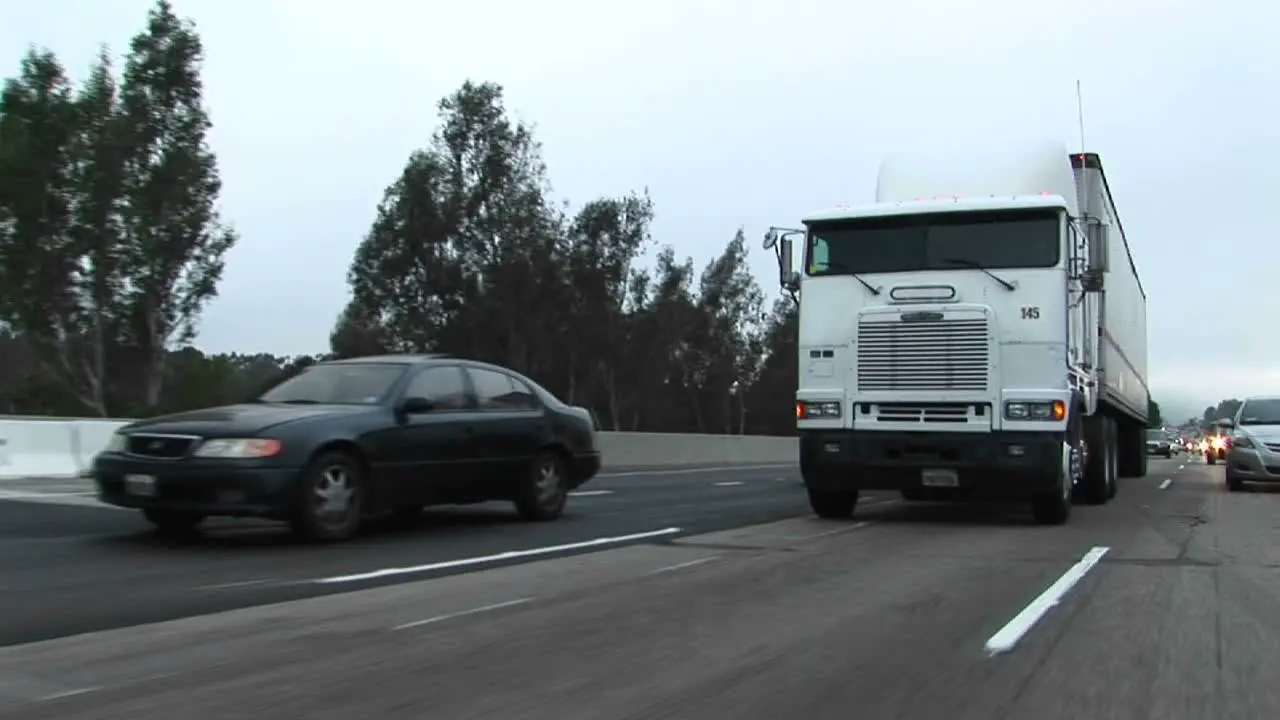 Cars and trucks drive on a crowded highway