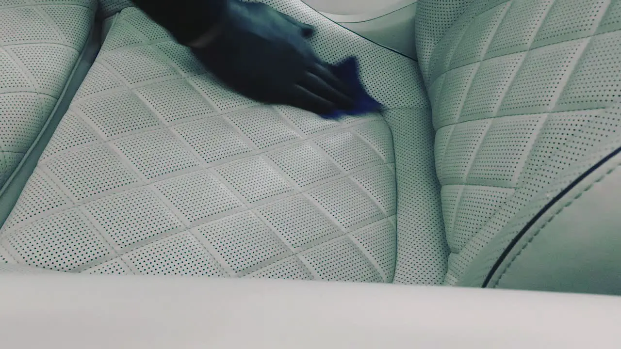 Cleaning a white leather chair in car