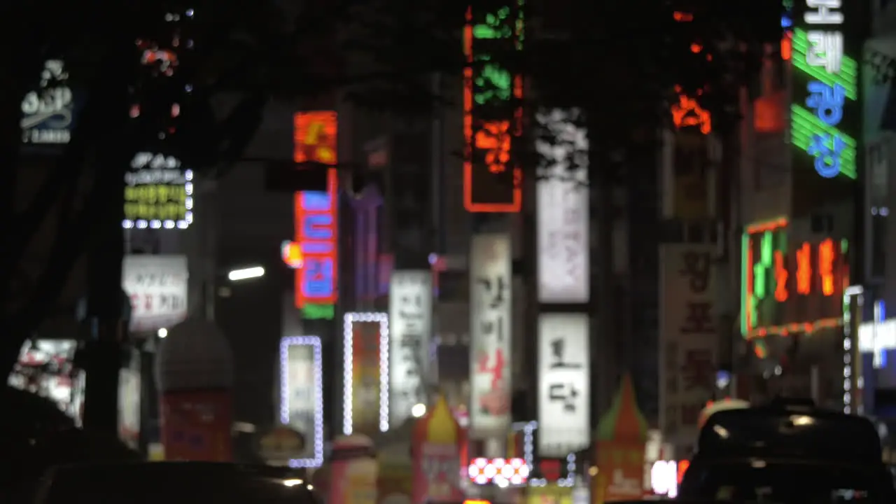 Advertising banners and car traffic in night Seoul South Korea