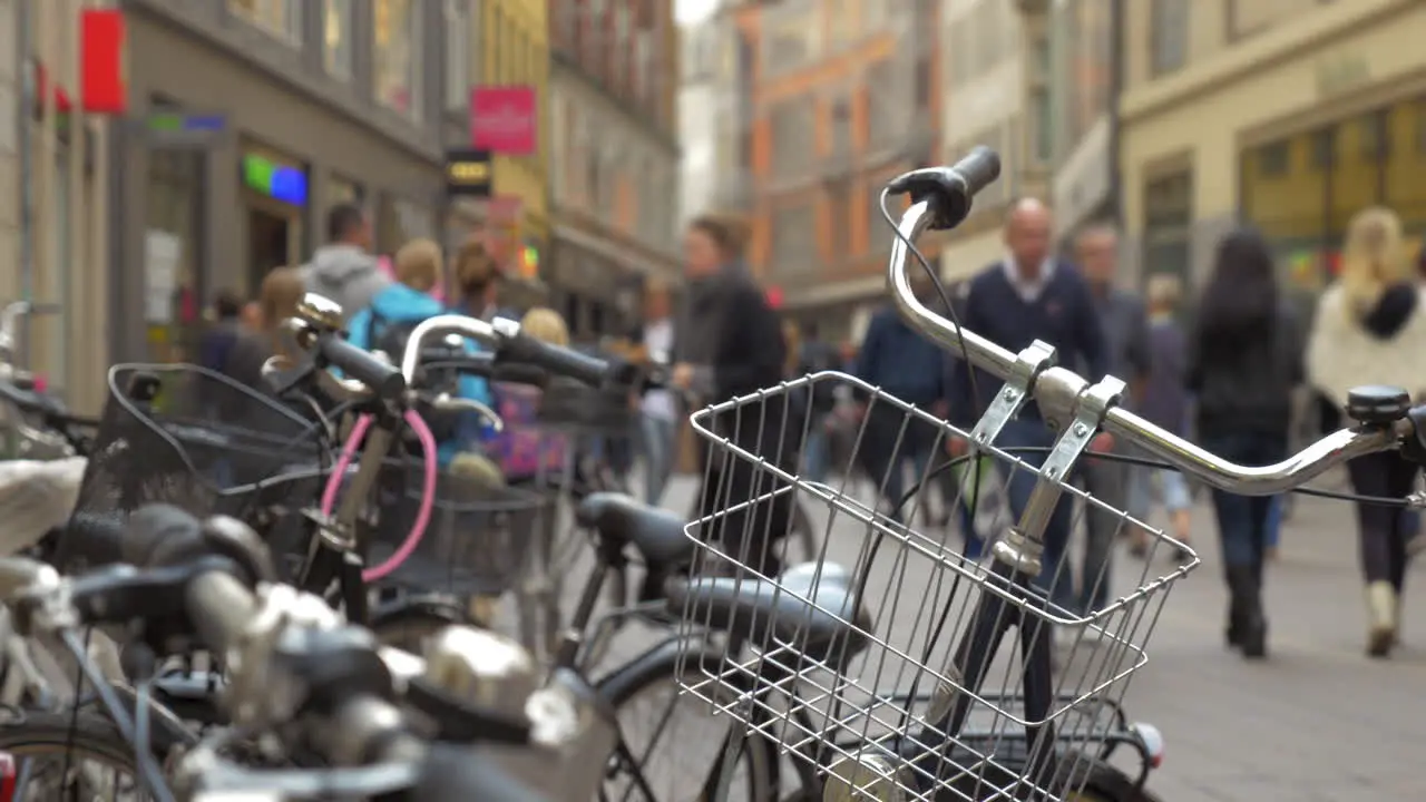 Parked bicycles and crowded city street