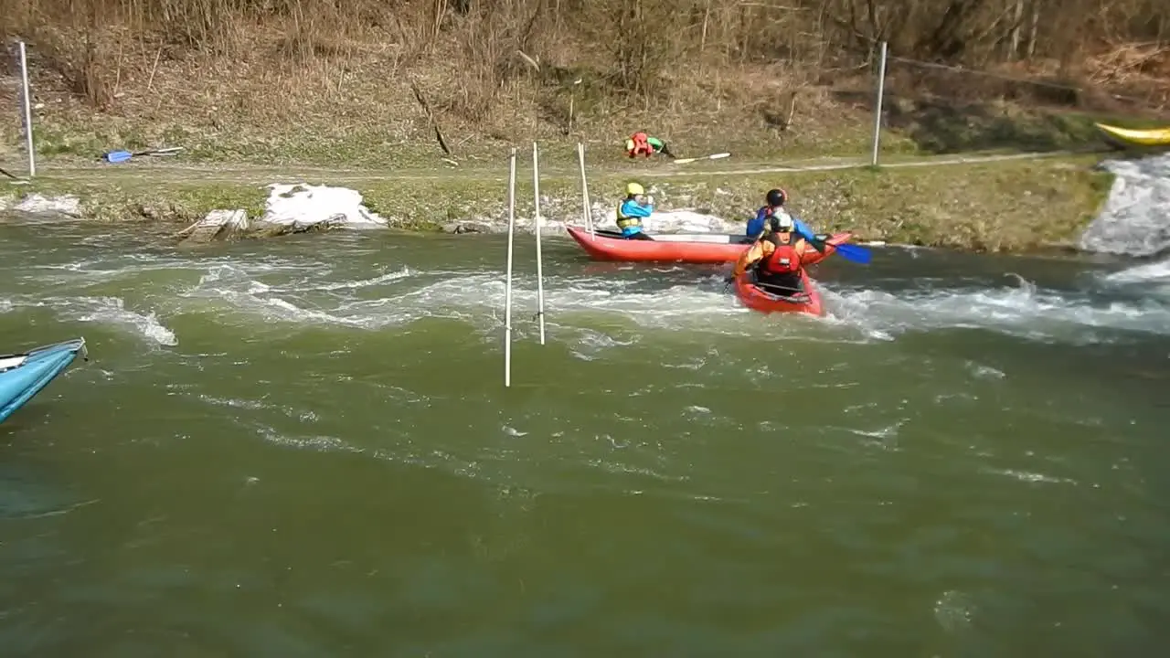 People struggling and learning to kayak and canoe on fast rapid river Slovakia