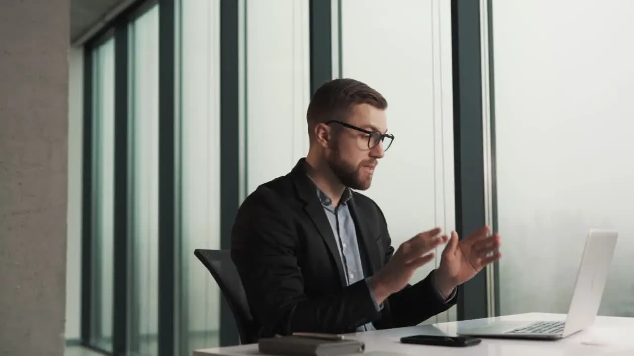 male office manager scolds and fires an employee from a remote job via video link via laptop