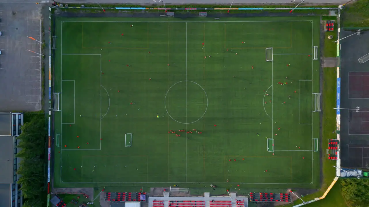 Top shot of a soccer field with people practicing field divided into smaller sections