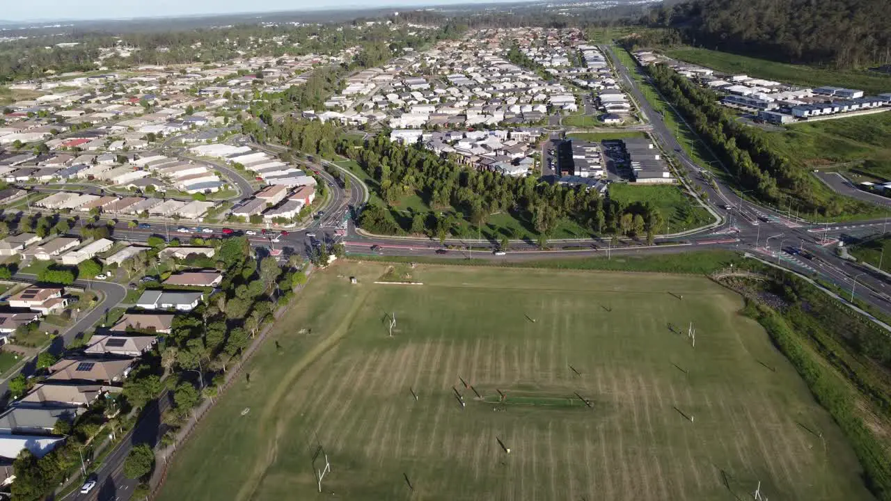 Flying over a football field with small town in background