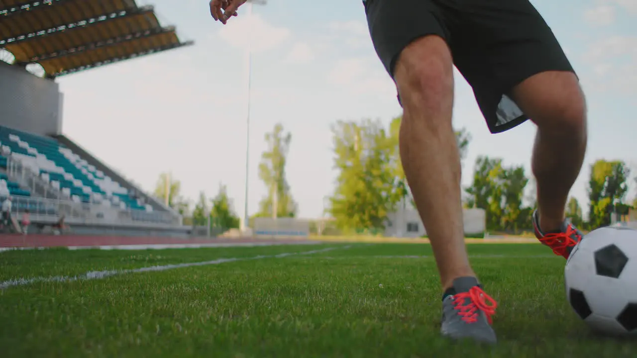 Skill professional soccer player a man runs in with a soccer ball on a soccer field in a stadium demonstrating excellent dribbling and ball control