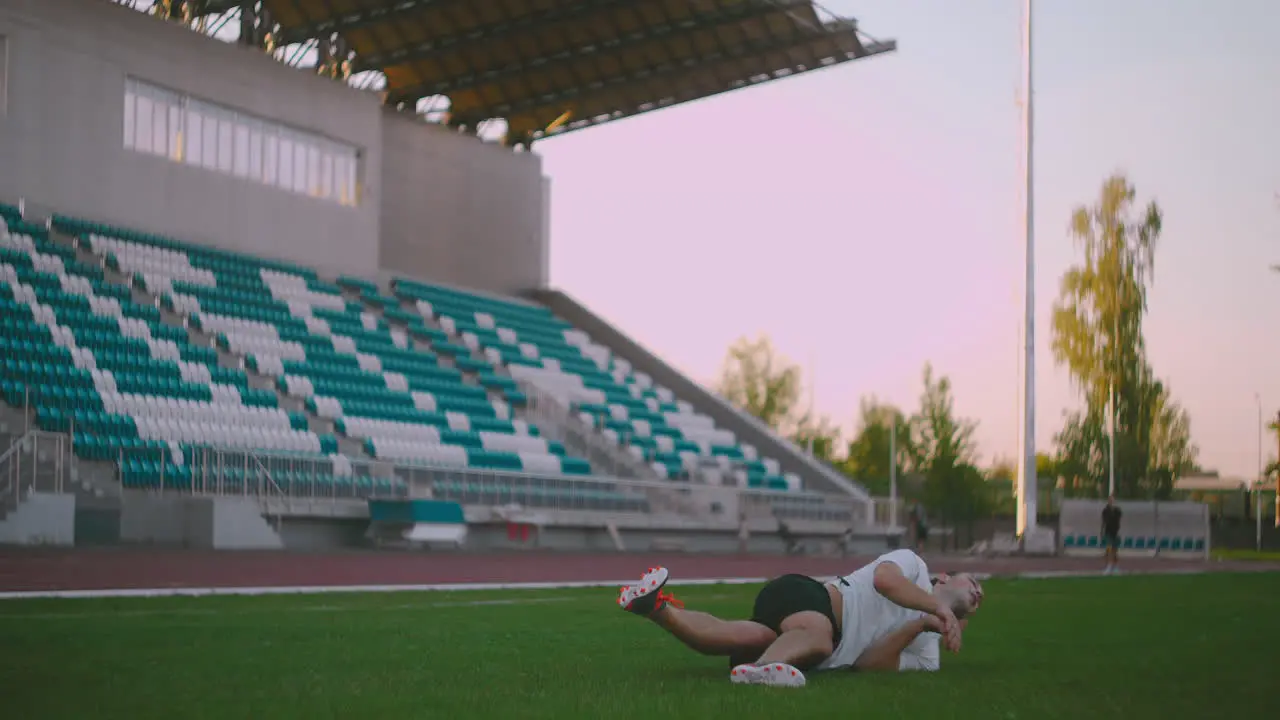 Soccer Player Kicking Ball in jump a soccer player in dramatic play during a soccer game on a professional outdoor soccer stadium Players wear unbranded uniform