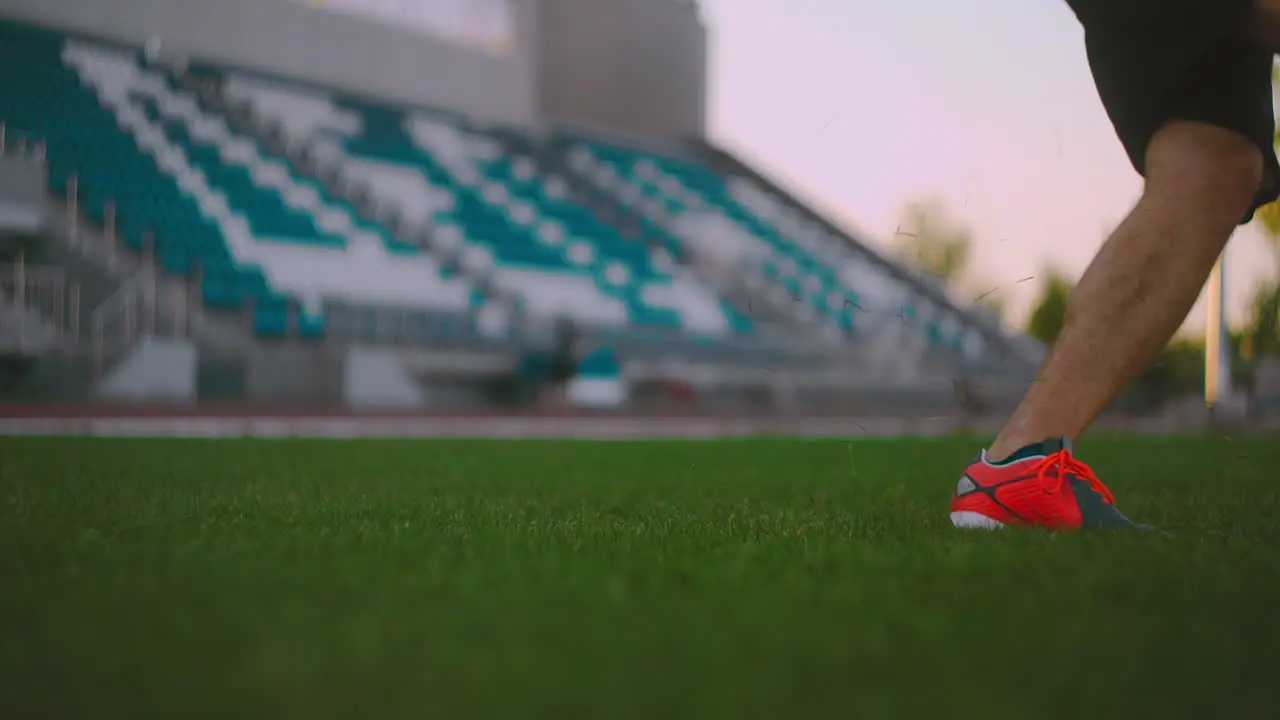 Set the socker ball on the lawn run and hit the ball in the stadium with a green lawn A professional soccer player kicks the ball in slow motion