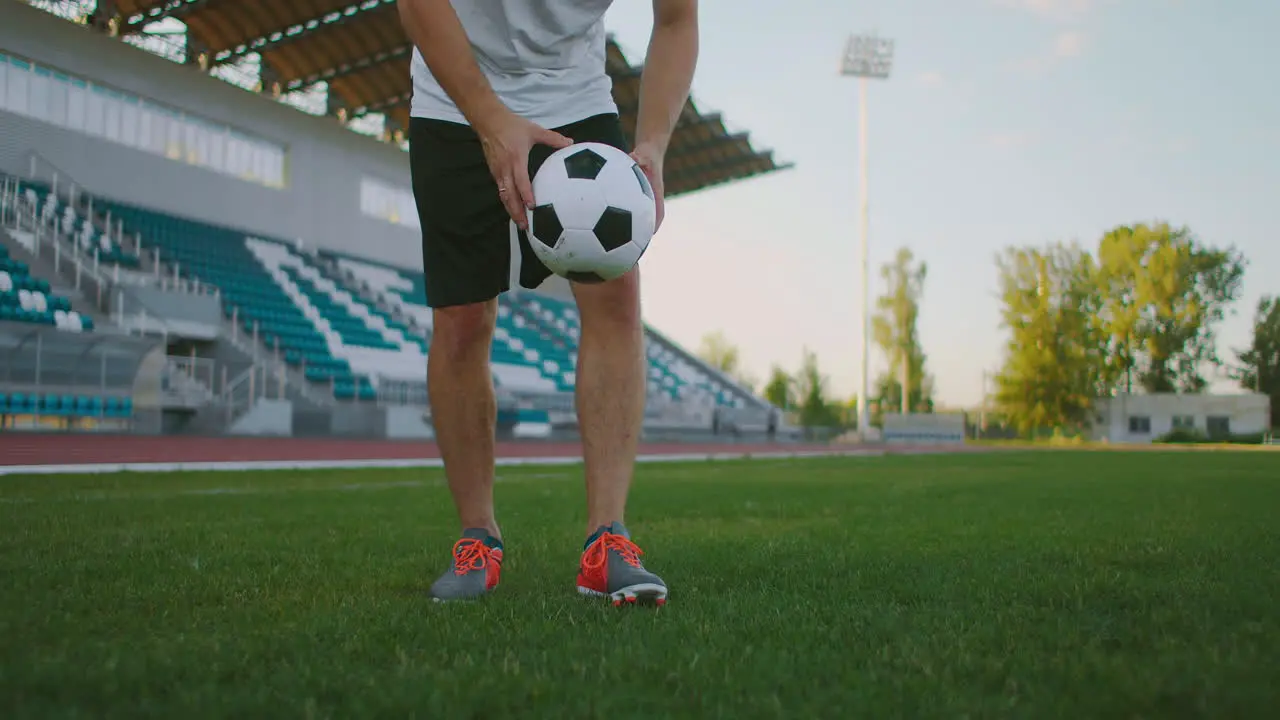 A professional soccer player in uniform receives a pass from a teammate handles the ball with his chest showing soccer skill and runs away from the opponents with the ball