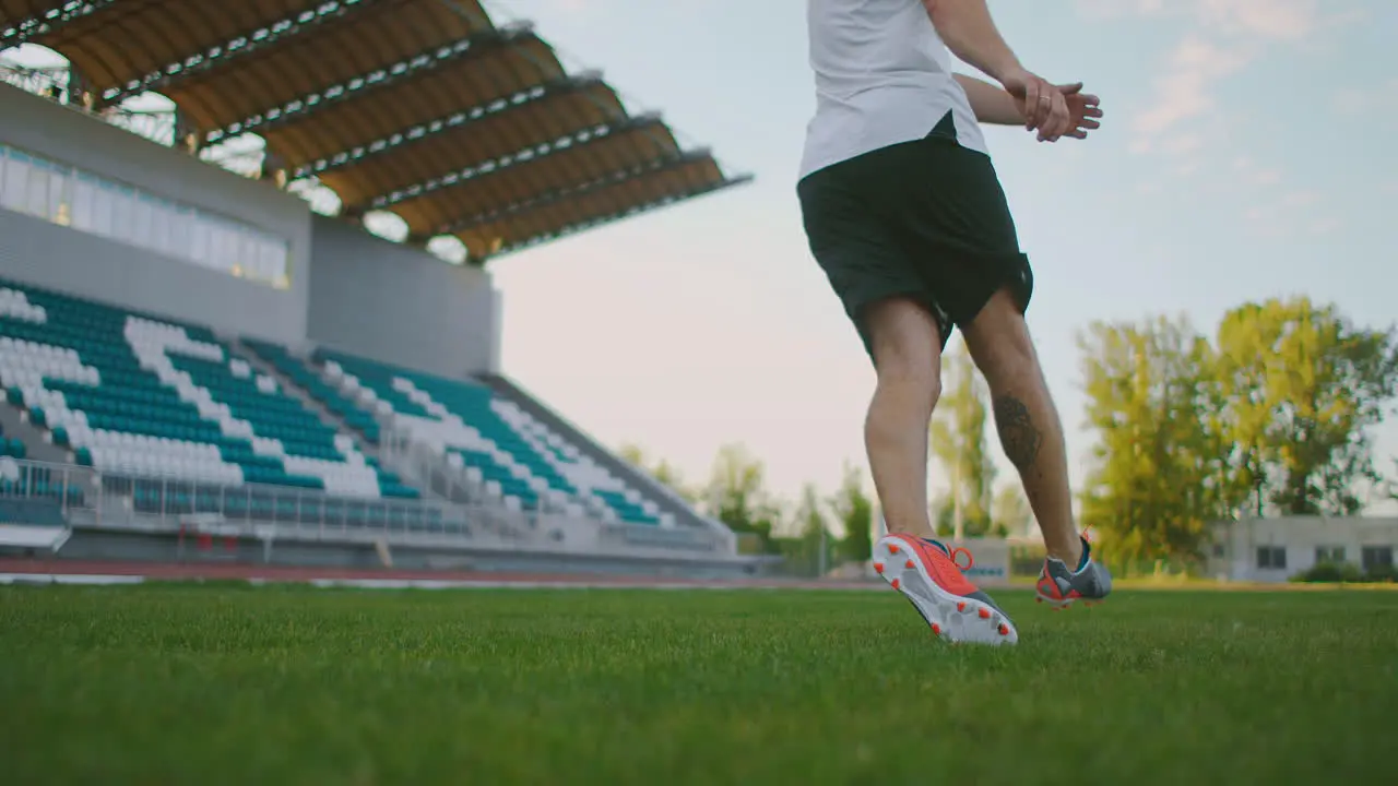 Close up in slow motion kicking a soccer ball in athletic cleats