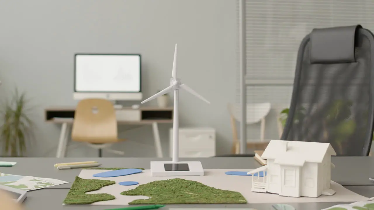 Wind Turbine Miniature And House Model On Office Table 1