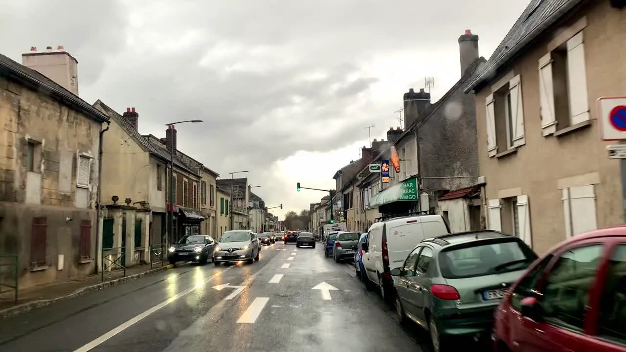 Camera pans forward with raindrops falling on the car window