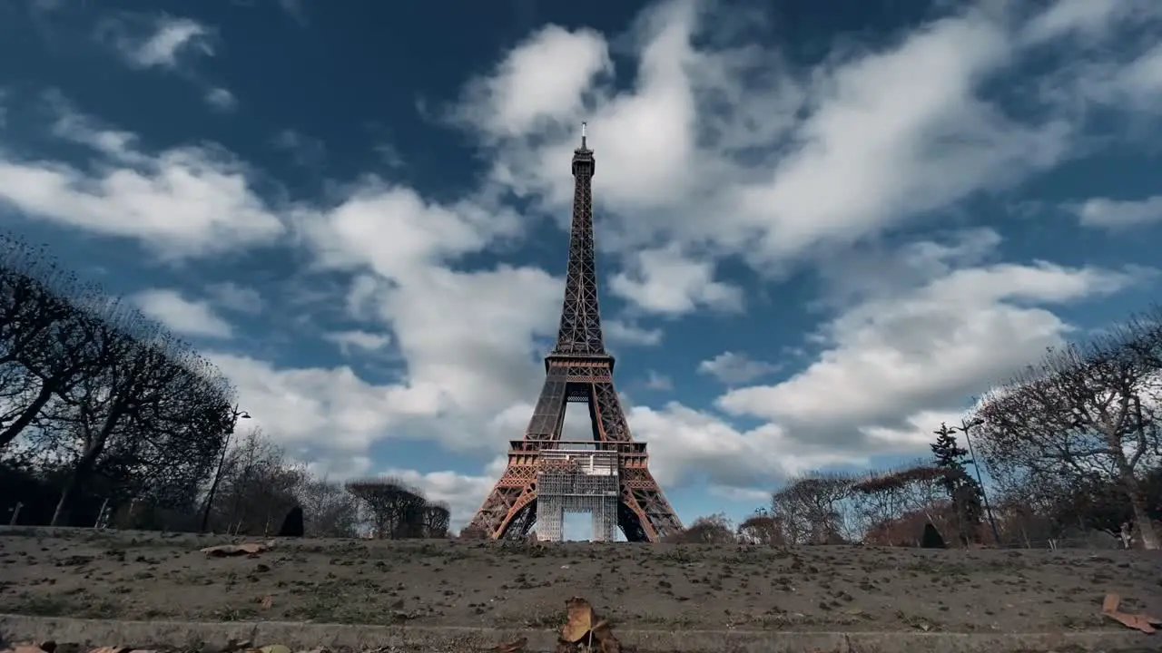 Eiffel Tower with moving clouds Landmark in Paris with Champ de Mars A Romantic Capital in Sunny Day Dramatic clouds at afternoon magnificent sky in fast motion