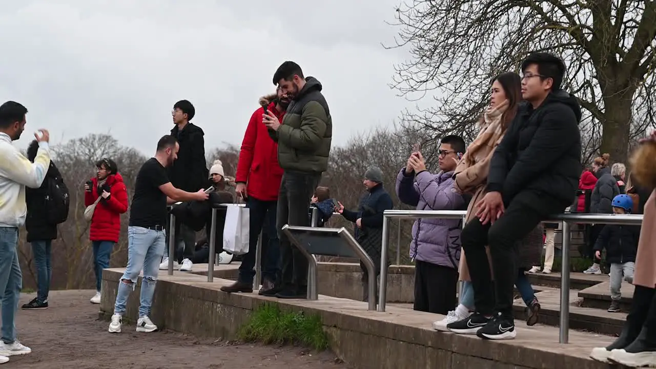 People taking pictures from the top of Greenwich Park London United Kingdom