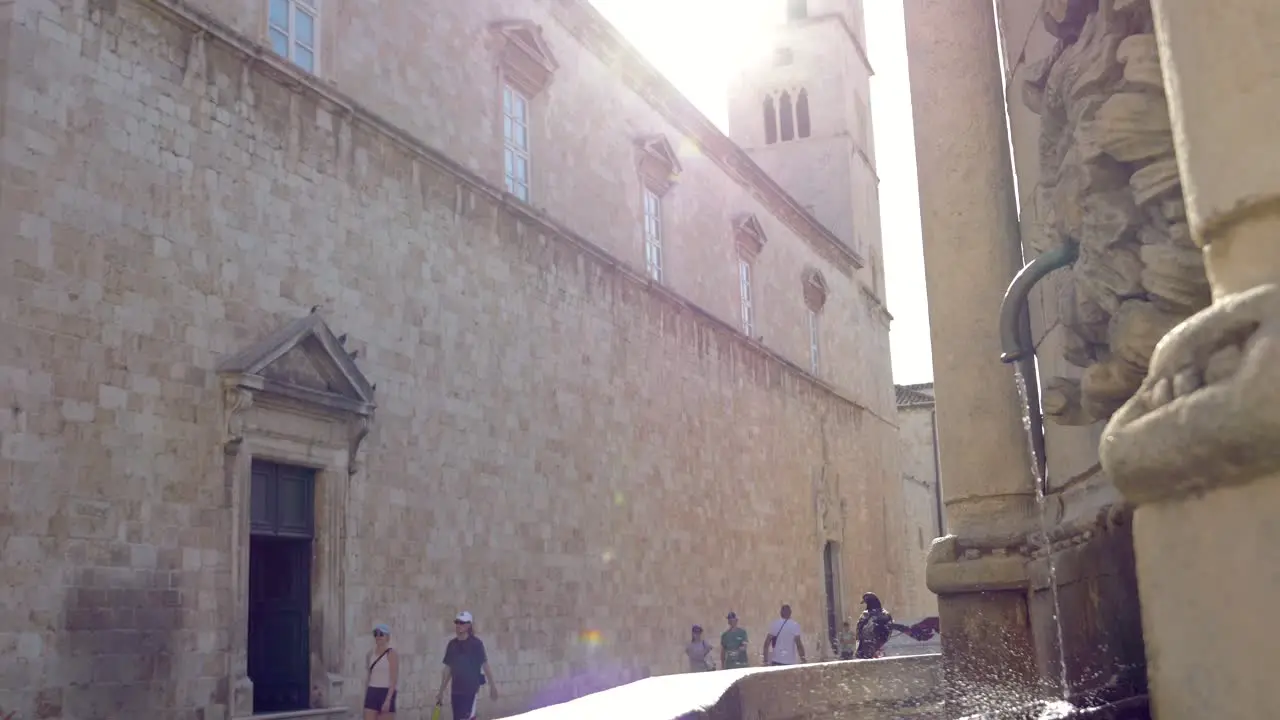 Dubrovnik sunny day above the walls of the old town water flowing from the fountain