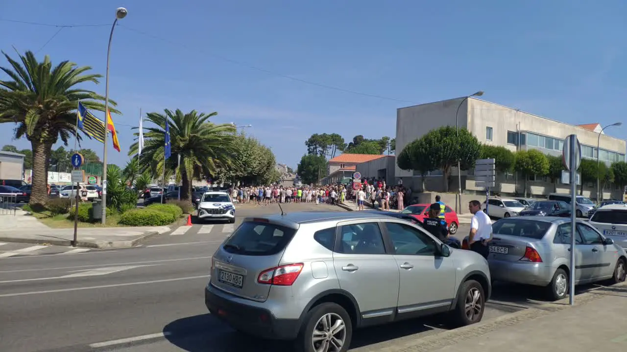 group of people demonstrate for quality universal public health in front of a health center police agents control the situation sunny day shot blocked