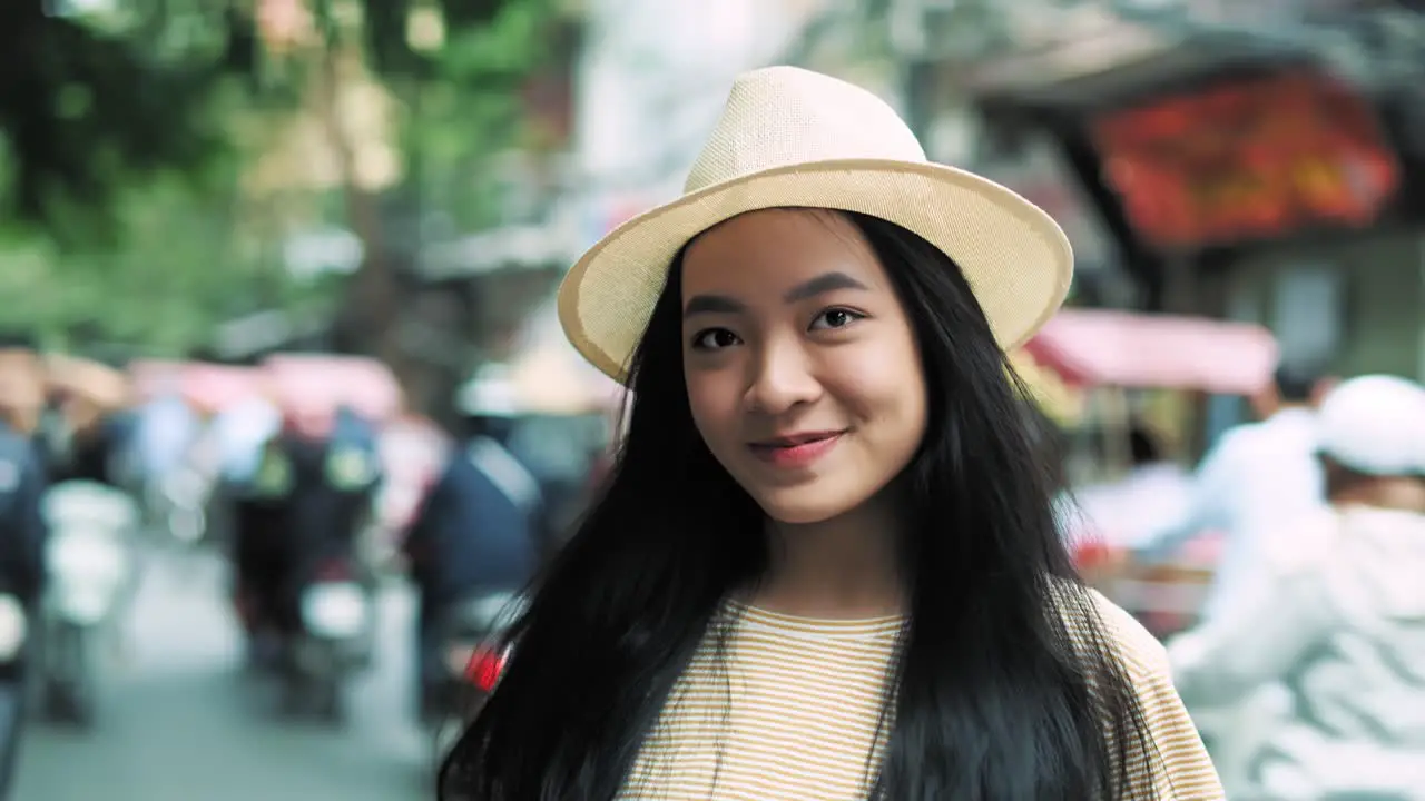 Handheld video shows of smiling Vietnamese woman in the city