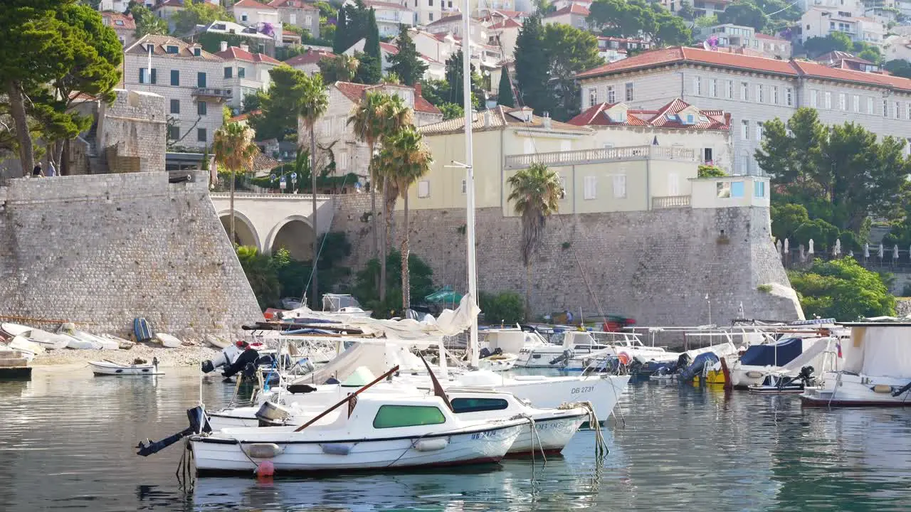 Dubrovnik yachts anchored in the harbor with city buildings in the background