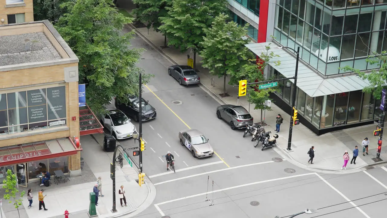 Urban Street Intersection in Vancouver City Downtown District Cars Traffic and Pedestrians at Crosswalk