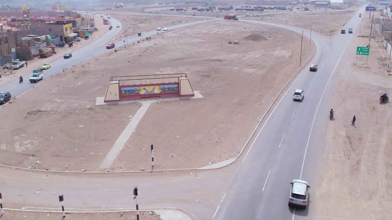 Aerial long shot with drone of the entrance to the city of Chiclayo in Peru while cars pass around on the highway