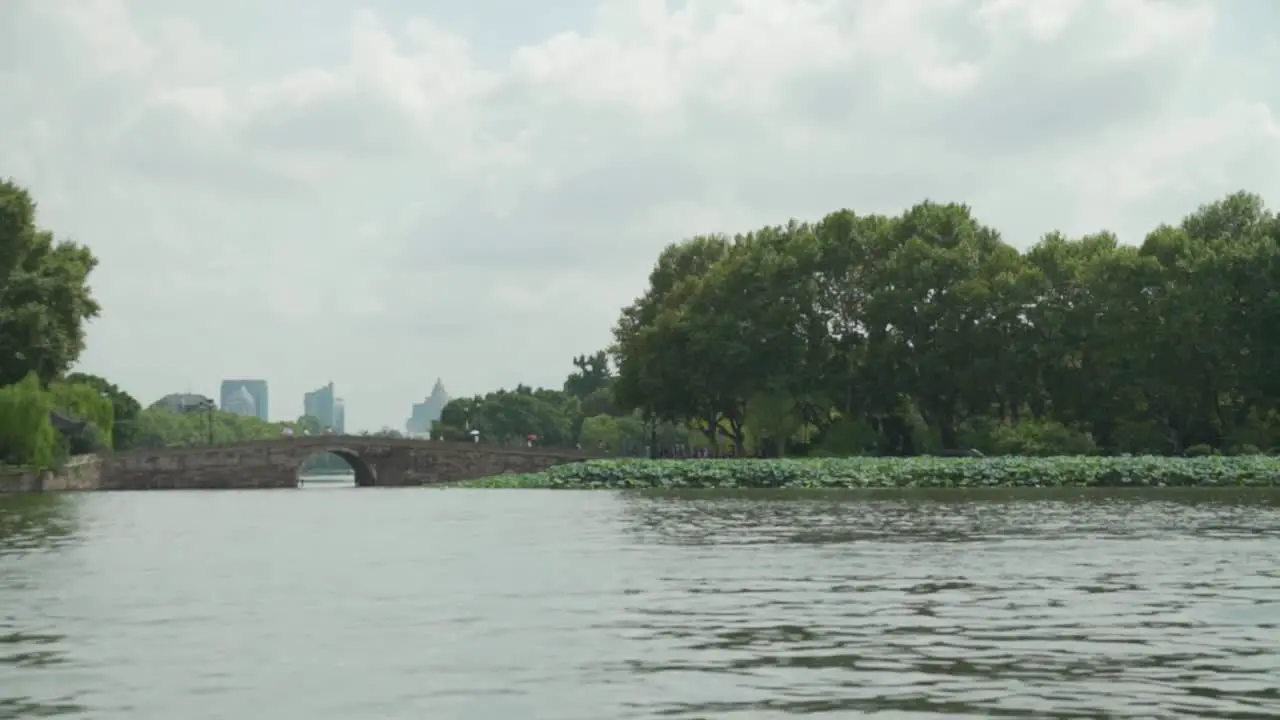 View from the West Lake in Hangzhou China with a bridge and the city in the background