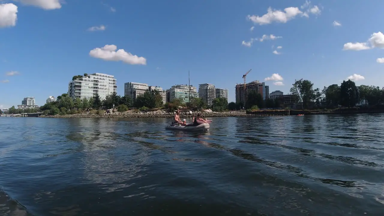 False Creek DT BC Canada Olympic Village harbor where Canadians relax on an inflatable boat sipping side by side consuming lots of alcohol despite COVID19 physical social physical distancing dingy2-7