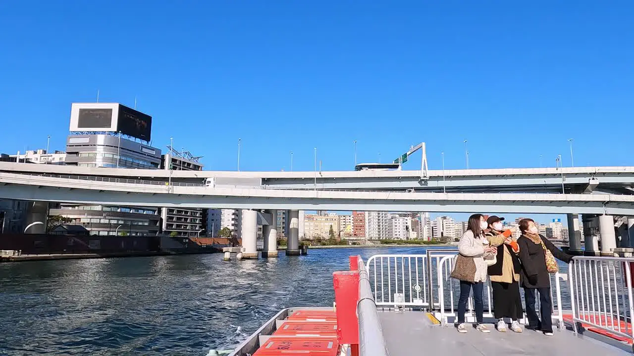 Tourists on the top of a boat taking photos