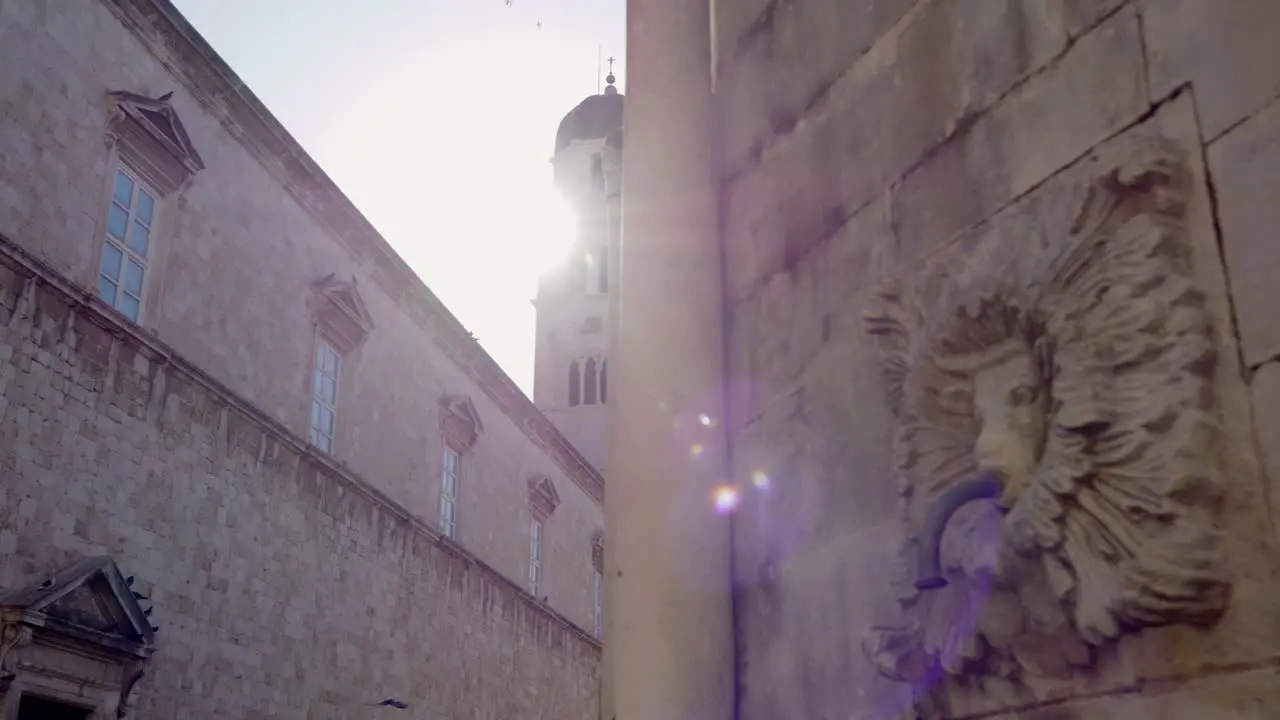 Dubrovnik clock tower illuminated by the rays of the morning sun